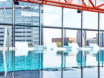 Spectacular amenity rooftop featuring our infinity style cocktail pool with waterfall feature and soaking deck, outdoor barbecue grilling stations, and ample lounge and dining seating areas